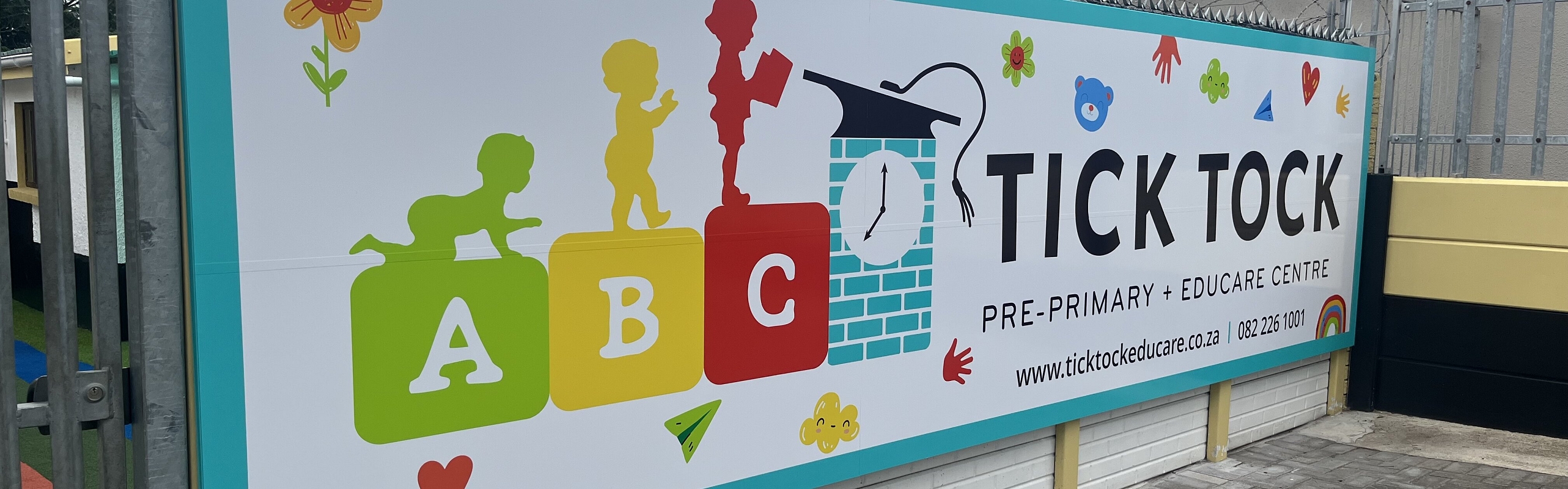 A large, eye-catching sign featuring the name of a school, designed to attract attention from passersby.