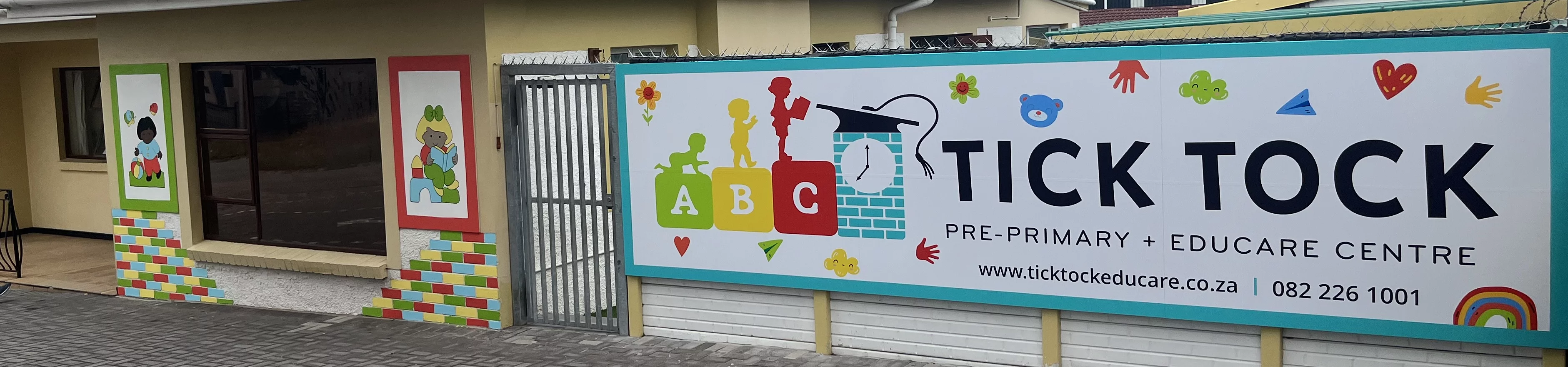 A prominent sign displaying the name of a school, set against a clear sky, emphasizing its educational significance.
