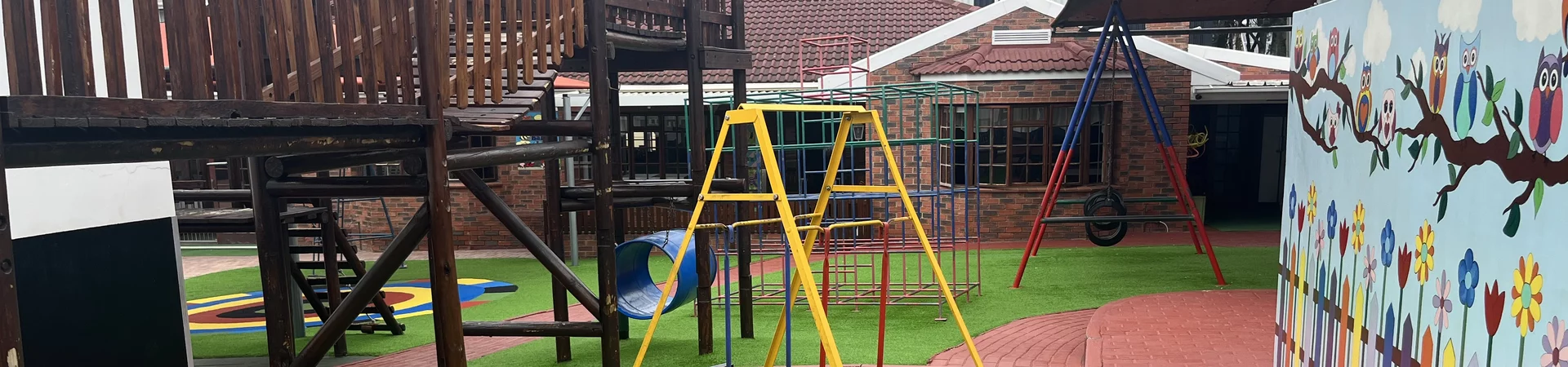 A vibrant playground featuring a slide, climbing frame, and various toys for children to enjoy and explore.