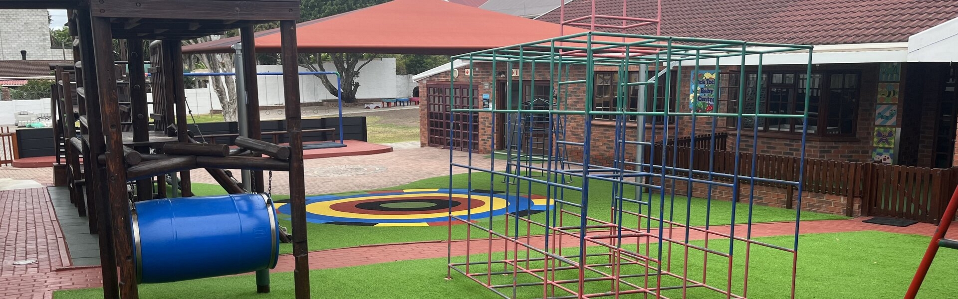 A colorful playground equipped with a slide, climbing frame, and assorted toys, inviting children to play and have fun.