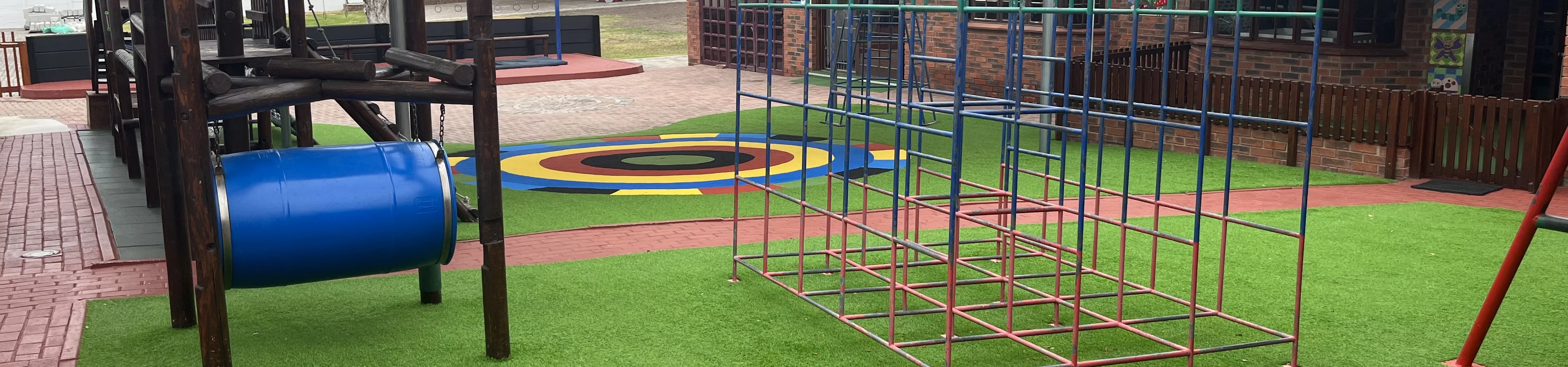A colorful playground equipped with a slide, climbing frame, and assorted toys, inviting children to play and have fun.