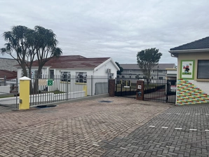 The entrance of Cherie House, highlighting its distinctive doorway and beautiful surroundings, creating an inviting atmosphere.