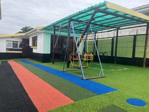 A vibrant playground featuring a swing set with a single swing, inviting children to play and enjoy outdoor activities.
