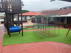 A lively playground displaying a swing set and a swing, designed for children