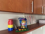 A bright kitchen featuring a sleek counter and wooden cabinets